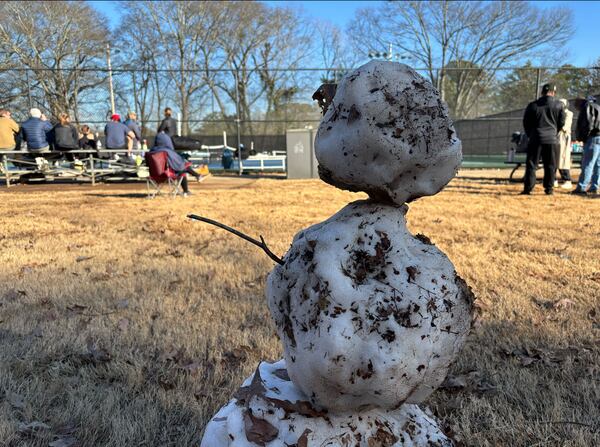 A rapidly melting snowman was among the remnants of the winter storm at Chastain Park on Sunday, Jan. 12, 2025. (David Aaro/AJC)