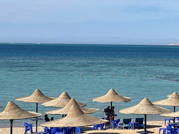 Tourists wait on the beach after a tourist submarine sank in the popular Egyptian Red Sea destination of Hurghada, Egypt, Thursday, March 27, 2025. (AP Photo)