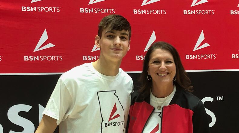 Wilson Sibley of North Oconee won the 2021 GHSA Slam Dunk Contest. He is with Carly Klingler, regional sales manager of BSN Sports, which sponsored the event.