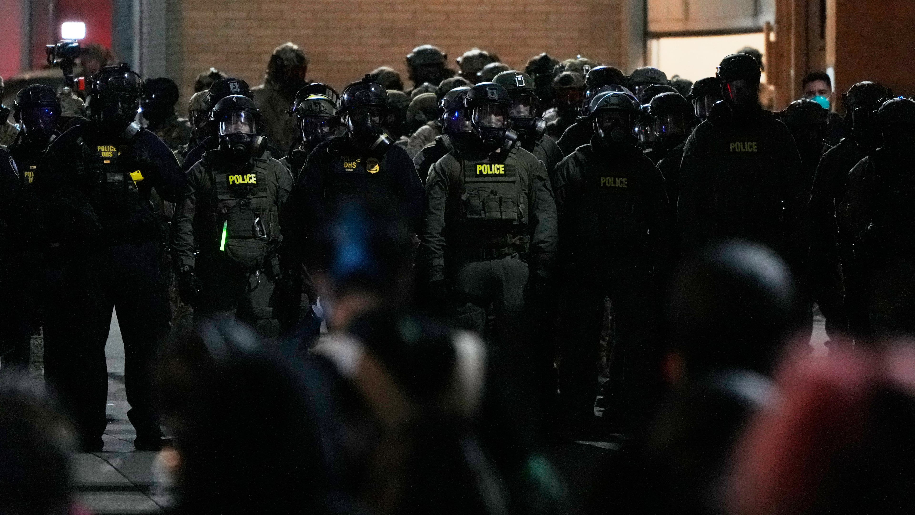 Law enforcement officers standoff against demonstrators outside a U.S. Immigration and Customs Enforcement facility during a protest on Saturday, Oct. 4, 2025, in Portland, Ore. (AP Photo/Jenny Kane)