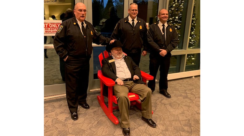 Cherokee County Commissioner and former Fire Chief Raymond Gunnin (seated) is honored upon his retirement from public service by (standing, from left) Fire Chief Tim Prather, Assistant Fire Chief Eddie Robinson, and Field Operations Chief Shane West.