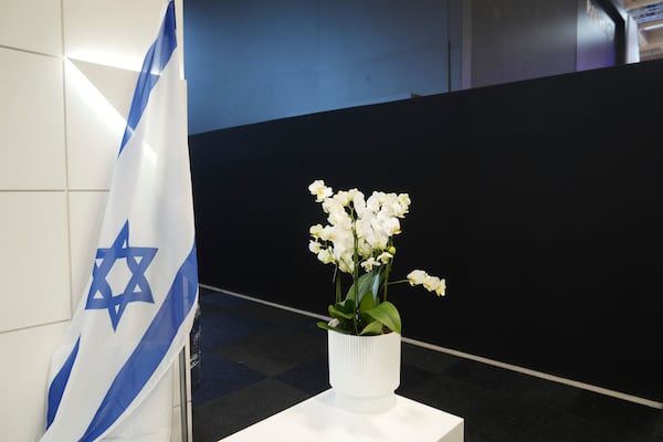 An Israeli flag is seen next to a black wall that blocks the Israeli pavilions erected at the Paris Air Show , Monday, June 16, 2025 in Le Bourget, north of Paris. (AP Photo/Michel Euler)