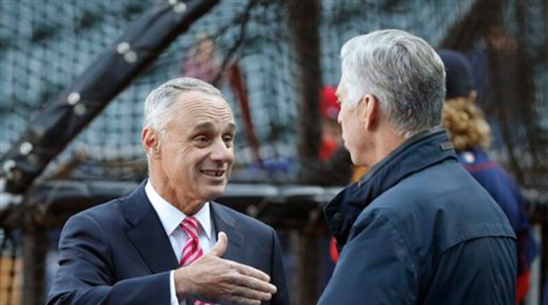 Major League Baseball commissioner Rob Manfred (left) helped lead the sport to a new collective bargaining agreement. (AP file photo/Charles Rex Arbogast)