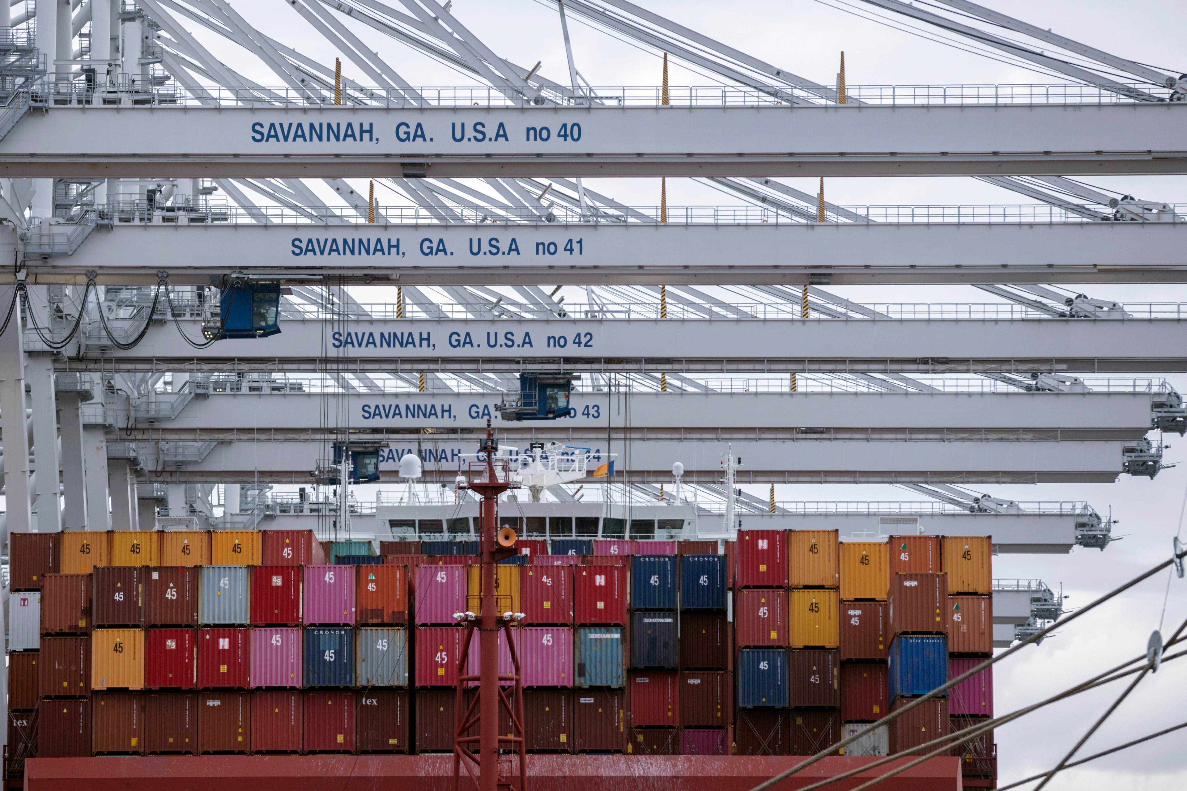 In this photo provided by the Georgia Ports Authority, a vessel is loaded with containers by several ship-to-shore cranes at the Port of Savannah Garden City Terminal, on Oct. 21, 2021, in Savannah, Ga. (Stephen B. Morton/AP via Georgia Ports Authority)