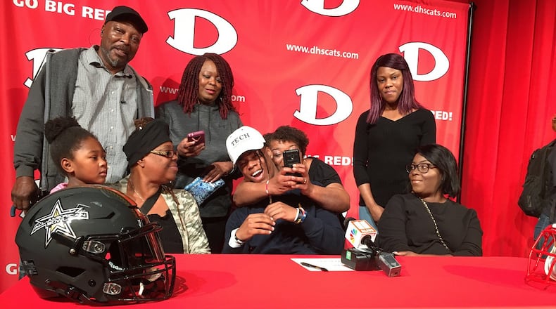 Dalton High running back Jahmyr Gibbs celebrates with family after he announced Wednesday, Feb. 5, 2020 that he will play football for the Georgia Tech Yellow Jackets. In the photo, counterclockwise from left: cousin Ah’triniti O’Neal, great uncle Daniel Wyche, aunt Carla Carmichael, great aunt Cassandra Wyche (with phone), mother Neka Willis, aunt Mia Willis, Gibbs and grandmother Angela Willis. (Photo by Ken Sugiura/AJC)