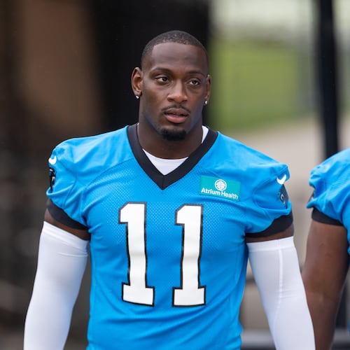 Carolina Panthers linebacker Nic Scourton (11) walks to the NFL football team's training camp Thursday, July 23, 2026, in Charlotte, N.C. (AP Photo/Scott Kinser)