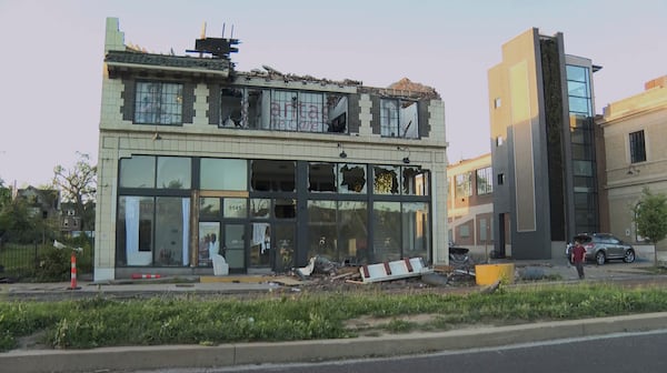 A building is damaged as debris covers the ground after a severe storm passed the area on Saturday, May 17, 2025 in St. Louis, Mo. ( KMOV via AP)