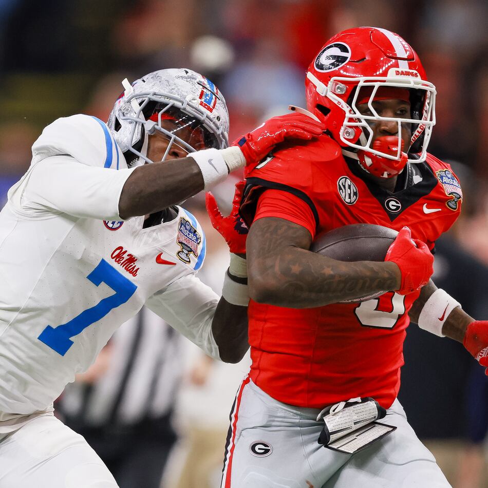 Georgia running back Nate Frazier (3) is stopped by Ole Miss safety TJ Banks (7) during the second quarter of the College Football Playoff quarterfinal game at the Sugar Bowl in the Caesars Superdome on Thursday, Jan. 1, 2026, in New Orleans. (Jason Getz/AJC)
