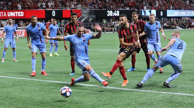 August 11, 2019 Atlanta: Atlanta United midfielder Justin Meram gets off a shot between New York City FC defenders in front of their goal in their soccer match on Sunday, August 11, 2019, in Atlanta. Curtis Compton/ccompton@ajc.com