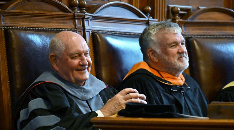 Sonny Perdue, chancellor of the University System of Georgia, smiles as he sits with Georgia Board of Regents Chairman Harold Reynolds during Perdue's investiture ceremony in September. The regents recently elected Reynolds to serve another year as its leader. (Hyosub Shin / AJC FILE PHOTO)