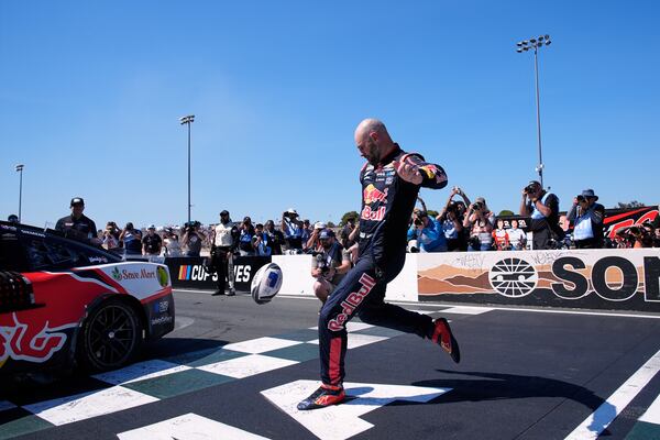 Shane van Gisbergen kicks a rugby ball as he celebrates after winning a NASCAR Cup Series auto race at Sonoma Raceway, Sunday, July 13, 2025, in Sonoma, Calif. (AP Photo/Godofredo A. Vásquez)