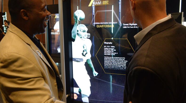 In the actual Hall of Fame, the names of Hall of Famers are etched into glass. Gone are the plaques from South Bend, replaced by 55-inch touchscreens on swivels. KENT D. JOHNSON / KDJOHNSON@AJC.COM