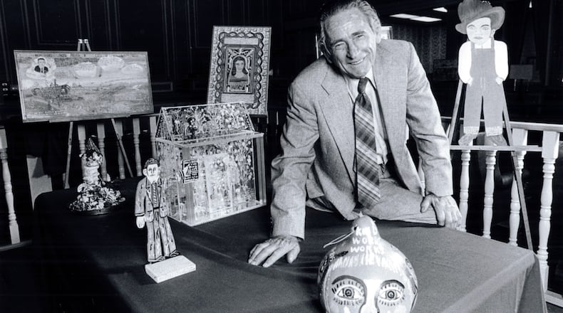 In this 1985 file photo, Howard Finster was shown with his folk art, which was on display in the National Bank of Chattooga County in Summerville. (AJC file photo)