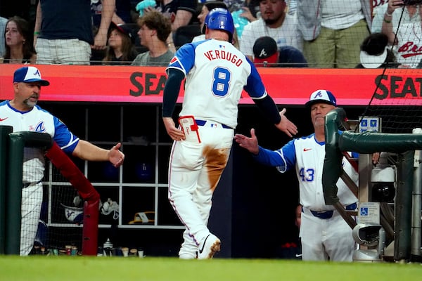 Atlanta Braves' Alex Verdugo (8) is greeted at the dugout by Atlanta Braves manager Brian Snitker (43) after scoring against the Minnesota Twins during the third inning of a baseball game Saturday, April 19, 2025, in Atlanta. (AP Photo/ John David Mercer)