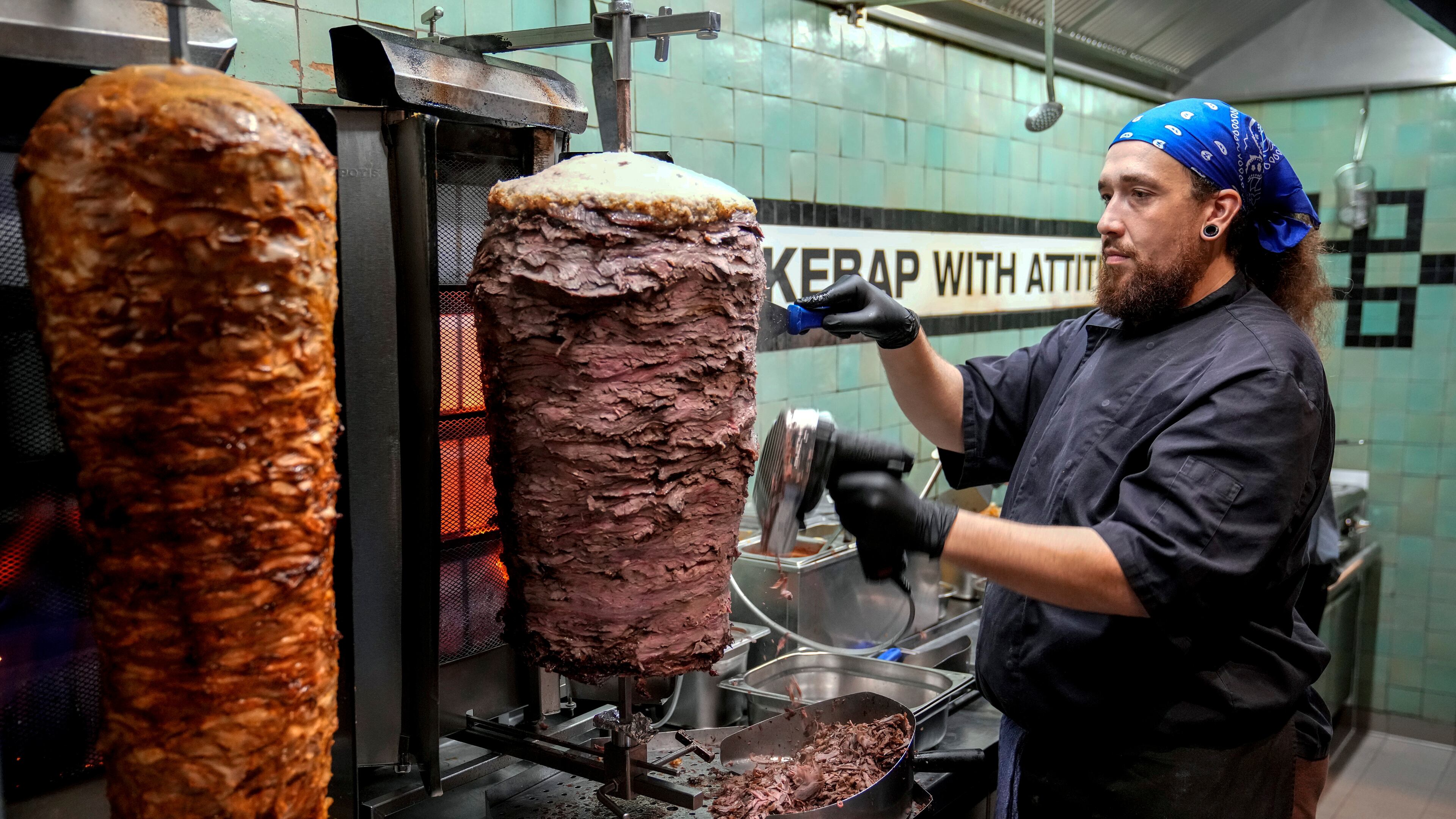 FILE - Doner chef Hvesley Silva cuts doner kebab in a doner kebab restaurant in Berlin, Germany, Monday, Sept. 16, 2024. (AP Photo/Ebrahim Noroozi, File)