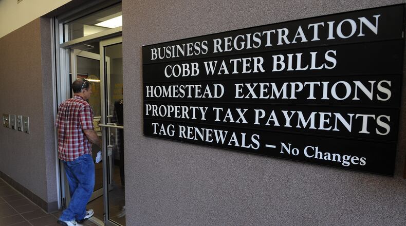 A customer enters the Cobb County Government Service Center in Austell. File photo.