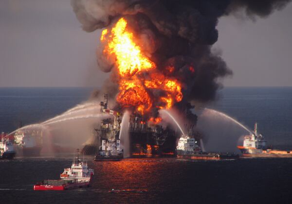 FILE - In this April 21, 2010 file photo provided by the U.S. Coast Guard, fire boat response crews spray water on the burning BP Deepwater Horizon offshore oil rig. (U.S. Coast Guard via AP, File)