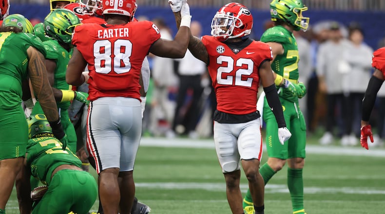 Georgia defensive lineman Jalen Carter (88) and defensive back Javon Bullard (22) celebrate a defensive stop against the Oregon Ducks at Mercedes Benz Stadium, Saturday, September 3, 2022, in Atlanta. Georgia won 49-3. (Jason Getz / Jason.Getz@ajc.com)