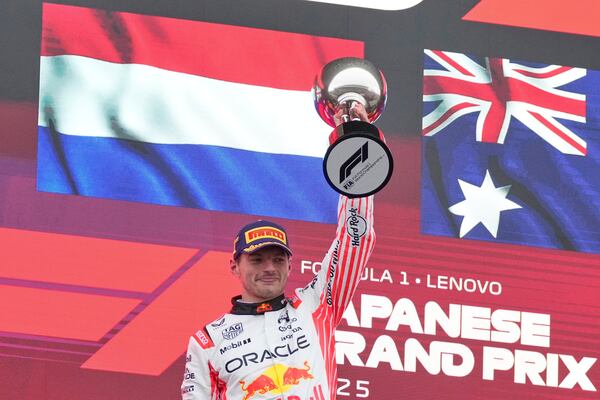 Red Bull driver Max Verstappen of the Netherlands celebrates with his trophy after winning the Japanese Formula One Grand Prix at the Suzuka Circuit in Suzuka, central Japan, Sunday, April 6, 2025. (AP Photo/Shuji Kajiyama, Pool)