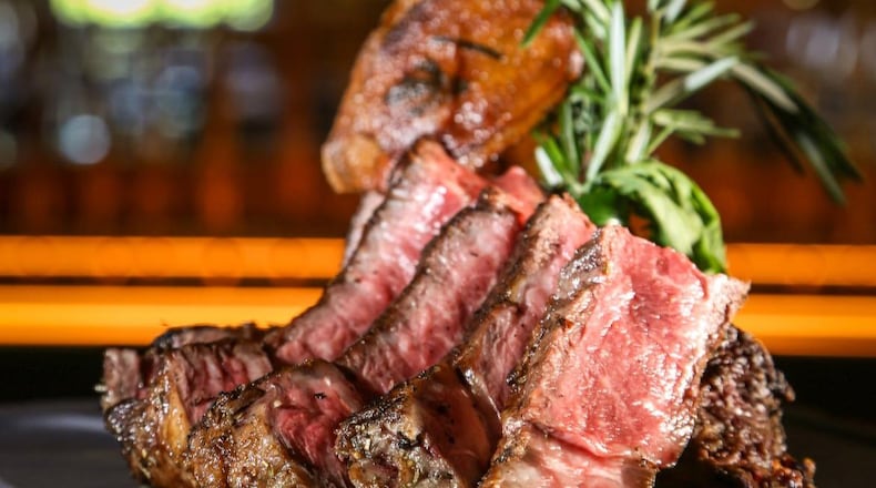 A tomahawk rib-eye is one of many steaks served at the Meat Market in Palm Beach, Fla. CONTRIBUTED BY BEN RUSNAK