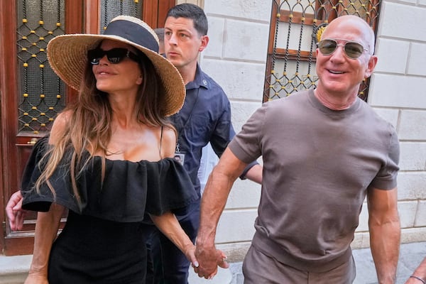 Lauren Sanchez Bezos and Jeff Bezos leave the Harry's Bar in Venice, Italy, Saturday,June 28, 2025, the day after their wedding. (AP Photo/Luca Bruno)