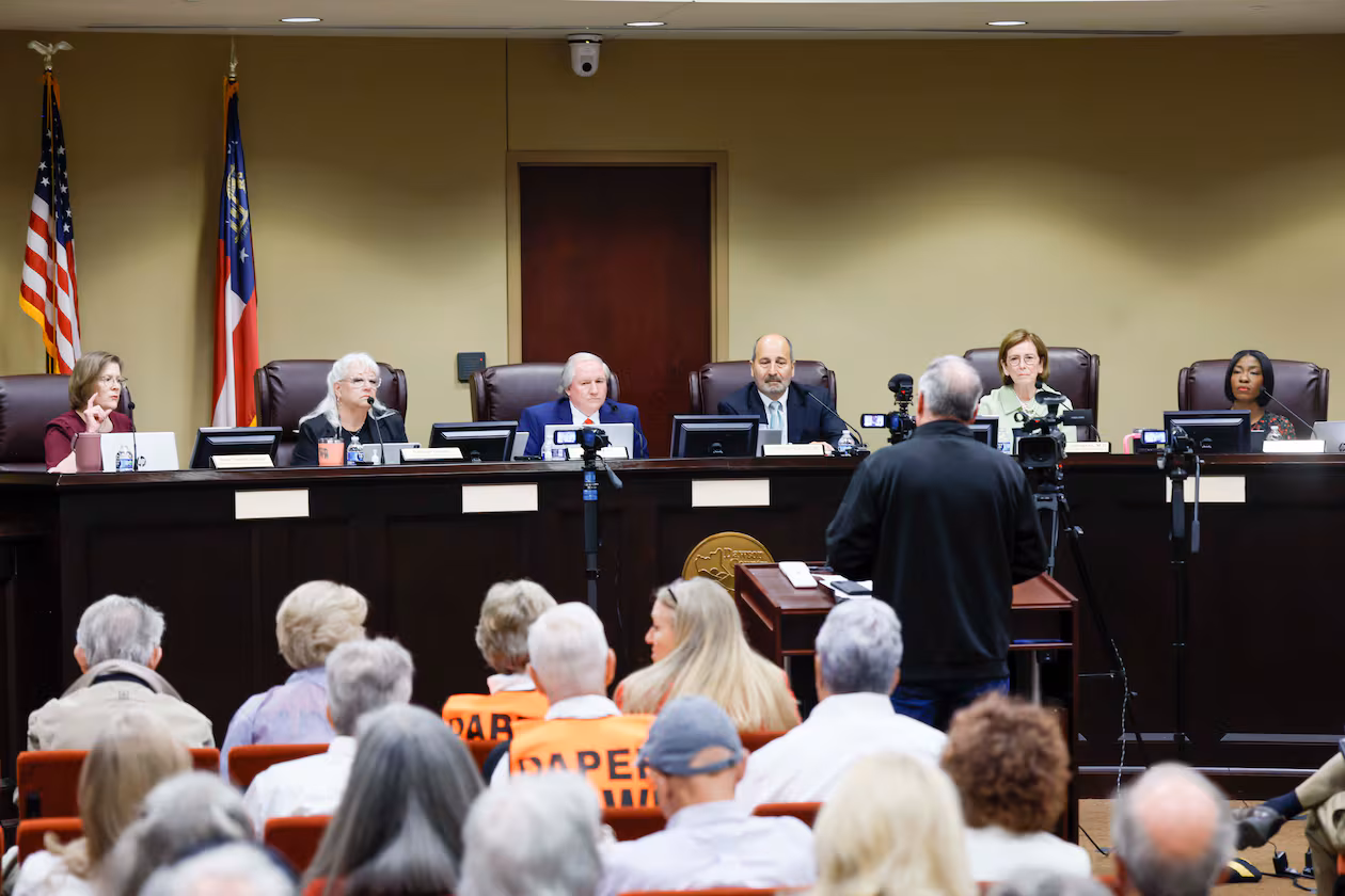 Board members listen to a speaker during a State Election Board meeting at Dawson County Government Center on Wednesday, April 15, 2026. (Miguel Martinez/AJC)