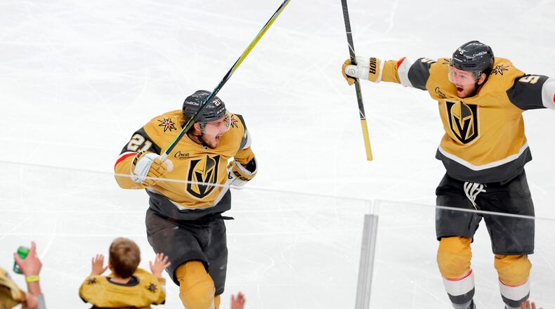 Vegas Golden Knights center Brett Howden, left, celebrates with Vegas Golden Knights defenseman Jeremy Lauzon (5) after scoring against the Utah Mammoth during second overtime of Game 5 in a first-round NHL hockey Stanley Cup playoff series Wednesday, April 29, 2026, in Las Vegas. (Steve Marcus/Las Vegas Sun via AP)