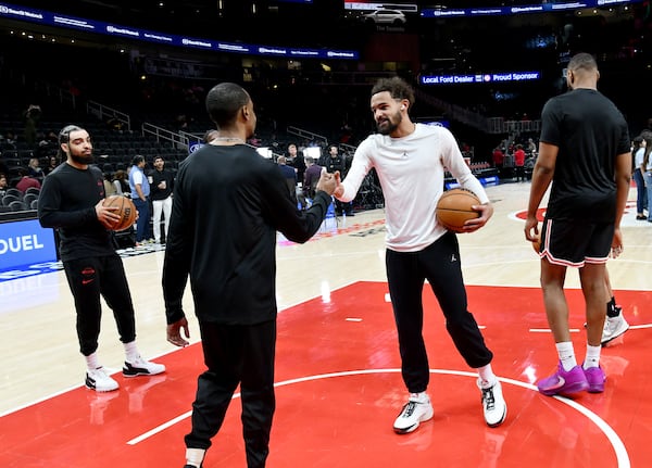Trae Young (second from right) makes the rounds before Wednesday's game against the Pelicans. It would be his last night as an Atlanta Hawk. (Hyosub Shin/AJC)