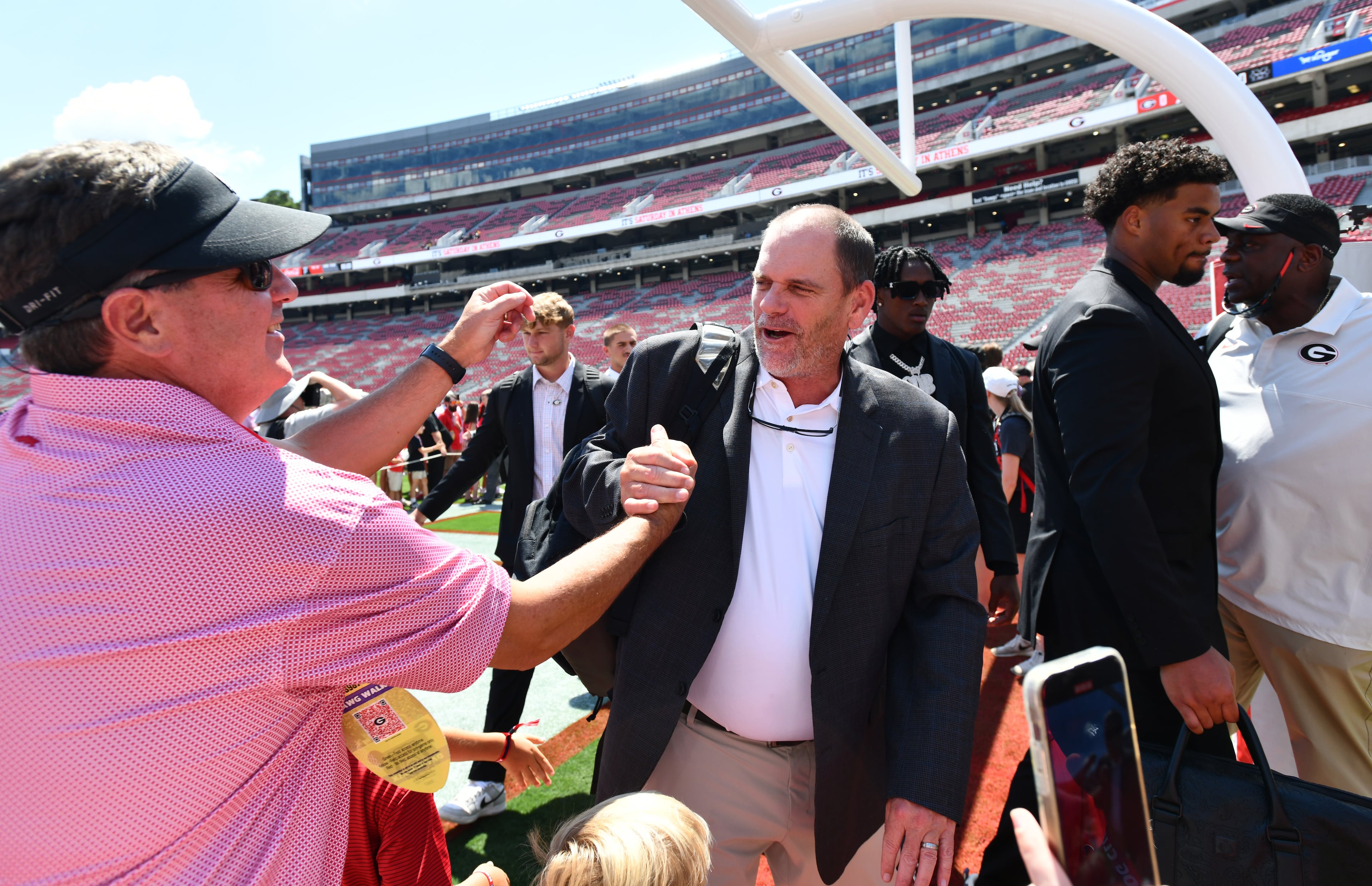 Georgia offensive coordinator and quarterbacks coach Mike Bobo is greeted by fans before Georgia football's season opener and home opener against Marshall at Sanford Stadium, Saturday, August 30, 2025, in Athens. (Hyosub Shin / AJC)