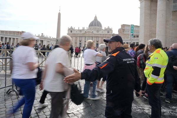 Faithful are channeled in St. Peter's Square at the Vatican, Wednesday, April 23, 2025 as the body of the late Pope Francis will lie in state inside St. Peter's Basilica for three days. (AP Photo/Markus Schreiber)