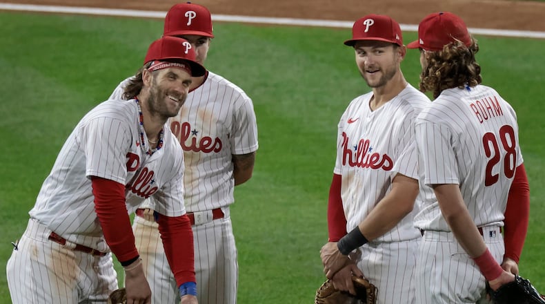 Philadelphia Phillies first baseman Bryce Harper, left, has already been named the starting first baseman for the National League in the All-Star Game. Shortstop Trea Turner, middle, and third baseman Alec Bohm, right, will join him in the lineup at shortstop and third base. (Elizabeth Robertson/The Philadelphia Inquirer/TNS)