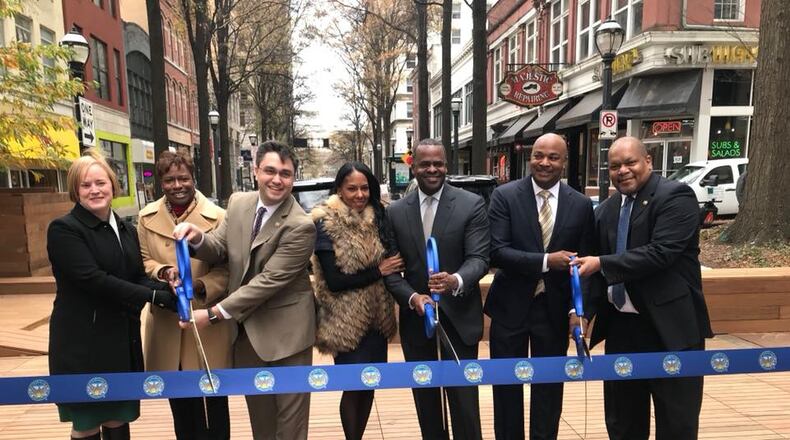 Mayor Kasim Reed along with other city officials cuts the ribbon on the new Broad Street Pedestrian Plaza, a gathering space with seating for restaurants and room for special events. CONTRIBUTED