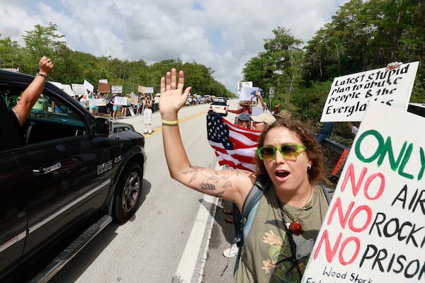 Environmental advocates and protesters at the Dade-Collier Training and Transition Airport on Tamiami Trail E, Ochopee, Fla., on Saturday, June 28, 2025, object to the "Alligator Alcatraz" being built at the facility. (Mike Stocker /South Florida Sun-Sentinel via AP)