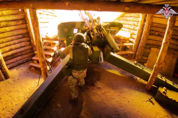 In this photo taken from video distributed by Russian Defense Ministry Press Service on Wednesday, July 16, 2025, a Russian soldier fires a 152 mm howitzer 2A65 Msta-B towards Ukrainian position in an undisclosed location in Ukraine. (Russian Defense Ministry Press Service via AP)