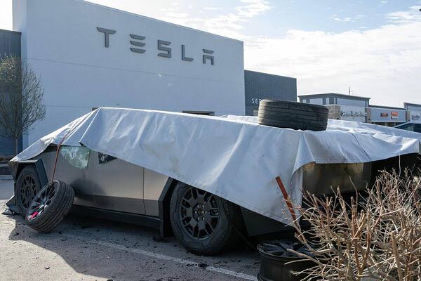 Fire-damaged Tesla Cybertrucks remain covered at a Tesla dealership on Tuesday, March 18, 2025, in Kansas City, Missouri. The cause of the fire is under investigation by bomb and arson authorities. (Emily Curiel/Kansas City Star/TNS)