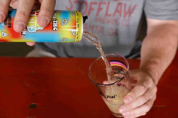 Scofflaw Beverage Co. co-founder Matt Shirah pours Uncle Arnie’s Iced Tea Lemonade, a THC-infused drink offered at the brewery. (Natrice Miller/AJC)