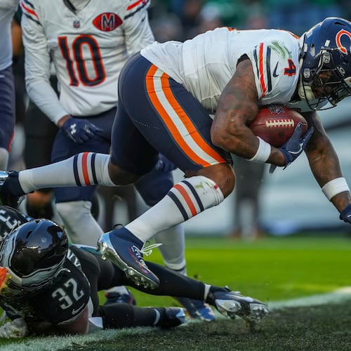 Chicago Bears running back D'Andre Swift (4) scores a touchdown during the first half of an NFL football game against the Philadelphia Eagles, Friday, Nov. 28, 2025, in Philadelphia. (AP Photo/Matt Slocum)