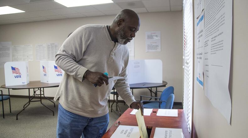 Dacula resident Denis Haynes Jr. casts his paper ballot during a special election in March for the City Council. Georgia’s delayed primary election will be held June 9.(ALYSSA POINTER/ALYSSA.POINTER@AJC.COM)