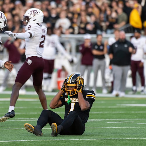 Missouri wide receiver Donovan Olugbode (1) grabs his helmet after missing a fourth-down reception as Texas A&M defensive tackle DJ Hicks (5) and cornerback Dezz Ricks (2) celebrate during the first half an NCAA college football game Saturday, Nov. 8, 2025, in Columbia, Mo. (AP Photo/L.G. Patterson)