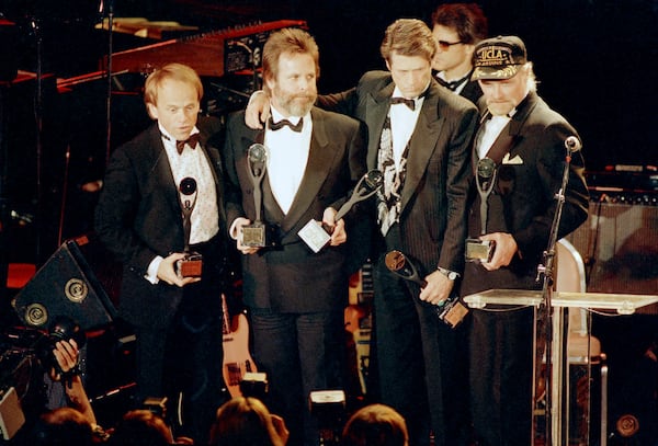 FILE - The Beach Boys, from left, Al Jardine, Carl Wilson, Brian Wilson and Mike Love, hold their trophies after being inducted into the Rock 'n' Roll Hall of Fame in New York, Jan. 21, 1988. (AP Photo/Ron Frehm, File)