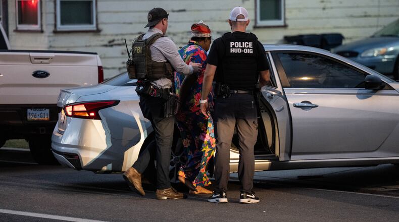 Lakiya Malone, center, charged with fraud involving federal homelessness aid programs, is arrested by federal agents in Los Angeles, Wednesday, Sept. 16, 2026. (AP Photo/Jae C. Hong)