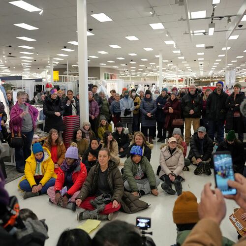 Community members and neighbors of people detained by ICE gather in protest at a Target store, Monday, Jan. 19, 2026, in St. Paul, Minn. (AP Photo/Yuki Iwamura)