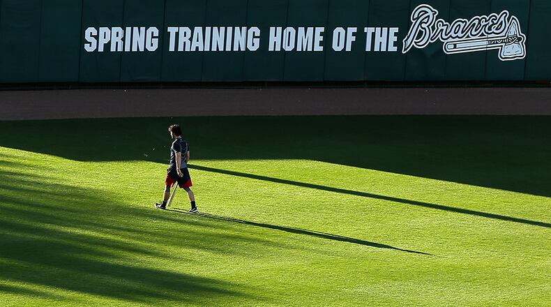 Baseball pennants in the outfield cast large shadows across the field at Champion Stadium as Braves top prospect Dansby Swanson makes an early morning walk to the batting cages to begin his day of spring training on Thursday, Feb 25, 2016, at the ESPN Wide World of Sports, Lake Buena Vista, Fla.