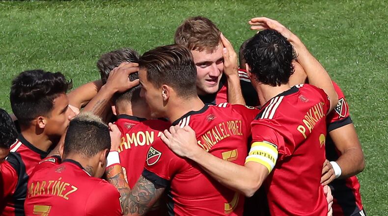 March 18, 2017, Atlanta: Atlanta United midfielder Julian Gressel is swarmed by his teammates after scoring a goal against the Chicago Fire for a 1-0 lead during the first half of their MLS game on Saturday, March 18, 2017, in Atlanta. Curtis Compton/ccompton@ajc.com