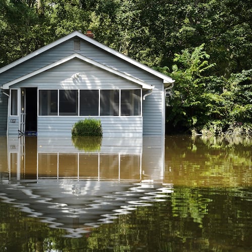 A flooded home is seen in Indianapolis, Sunday, Aug. 16, 2026. (AP Photo/Obed Lamy)