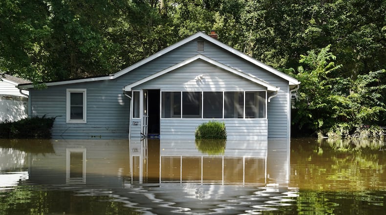 A flooded home is seen in Indianapolis, Sunday, Aug. 16, 2026. (AP Photo/Obed Lamy)