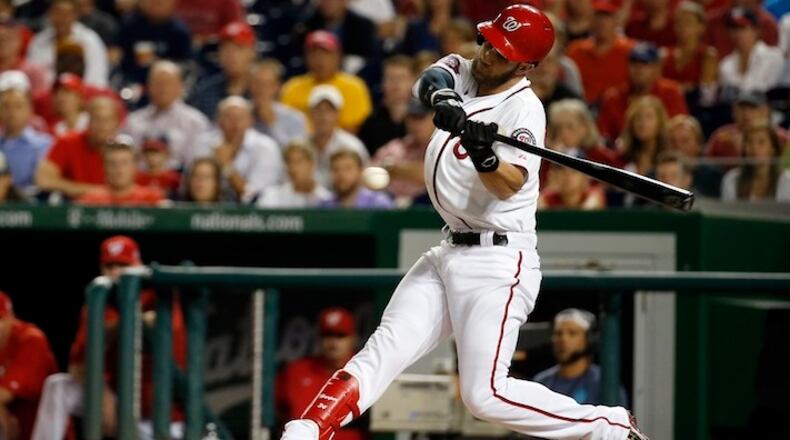 In this photo taken Aug. 27, 2015, Washington Nationals right fielder Bryce Harper (34) bats during a baseball game against the San Diego Padres at Nationals Park in Washington. As they try to forget about 2015 and get started on 2016 at spring training, the best news for the Washington Nationals is that unanimous NL MVP Bryce Harper is still around. (AP Photo/Alex Brandon)