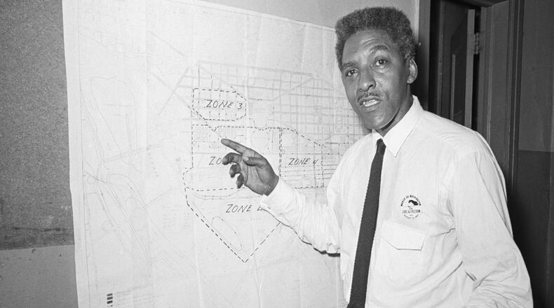 Bayard Rustin, New York deputy director of the March on Washington, pointing to map explaining march route.