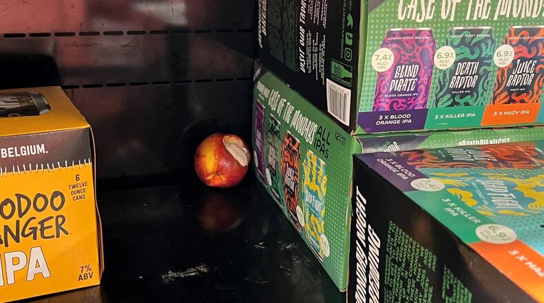 Residents have complained about the cleanliness at the Kroger Metropolitan Citi-Center. They have shown the alcohol License Review Board photos of litter on the shelves, including a half-eaten apple. Image credit: Neighborhood Planning Unit-X
