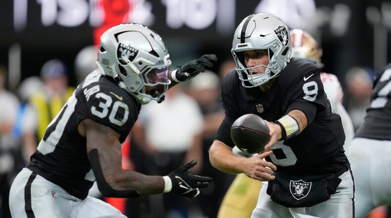 Las Vegas Raiders quarterback Kirk Cousins (8) hands off to running back Mike Washington Jr. (30) during the first half of an NFL preseason football game against the San Francisco 49ers, Thursday, Aug. 27, 2026}, in Las Vegas. (AP Photo/John Locher)